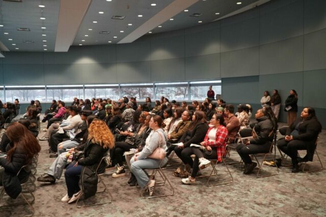 large group of people sitting in auditorium