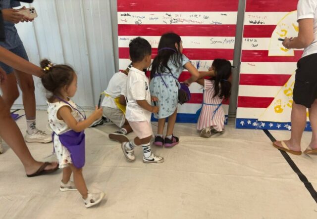 Children signing the mural